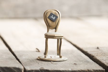 Job - inscription job and gold chair on the tableの写真素材