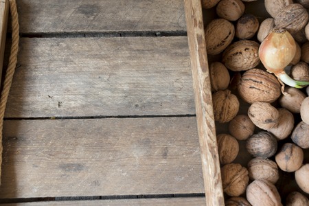 fresh walnuts in a wooden box on an old tableの写真素材