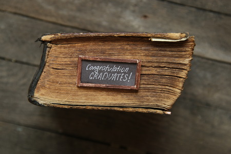 lettering congratulations graduates and old book - greeting, invitation card, vintage styleの写真素材