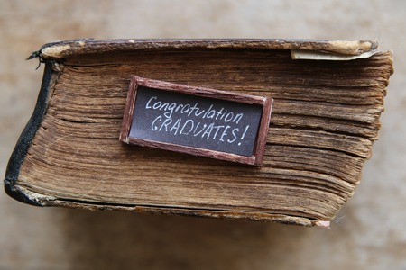 lettering congratulations graduates and old book - greeting, invitation card, vintage styleの写真素材
