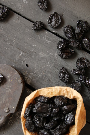 Raw organic prunes, dried plums on a dark backgroundの写真素材