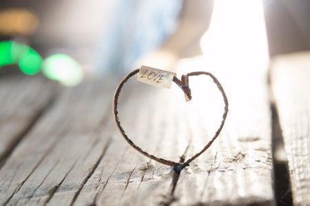 Love inscription and heart on vintage old wooden table