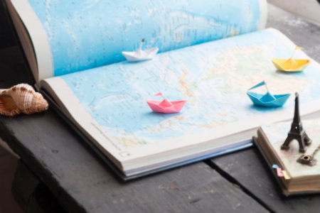 Travel to World. Tourism. Paper boats on the map.