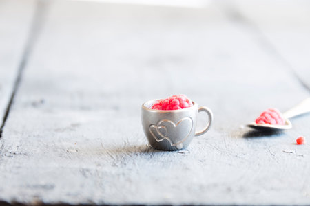 ripe raspberry in a cup on the table