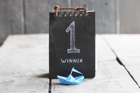 Number One First Place Winner idea, text and blue paper boatの写真素材