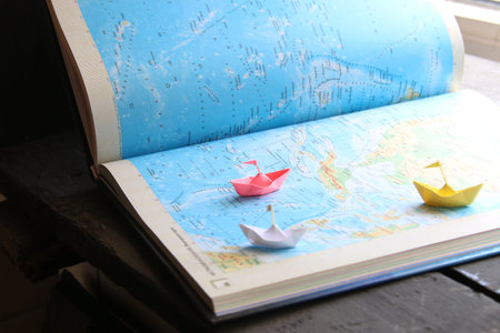 Shipping - Logistic Import Export idea - paper boats on the map