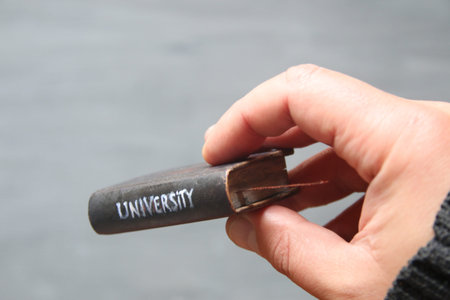Book with the inscription University. Soft focus