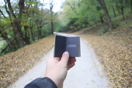 travel idea, hand holding a book with textの写真素材