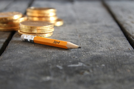Business idea concept. Pencil with inscription and gold coins.の写真素材