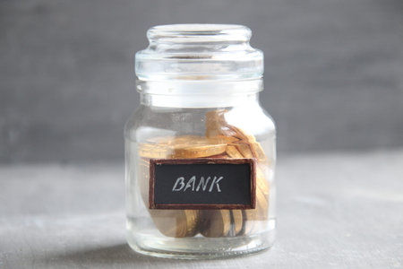 Business loan from a bank, jar with money and sign Bank