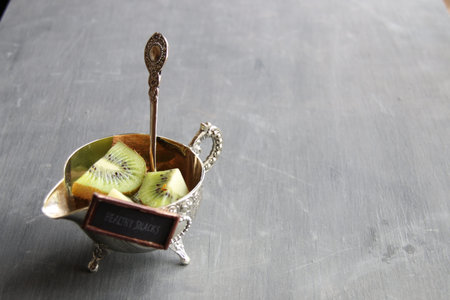 Healthy dinner ideas tag and Kiwi fruit on wooden background. Copy space.の写真素材
