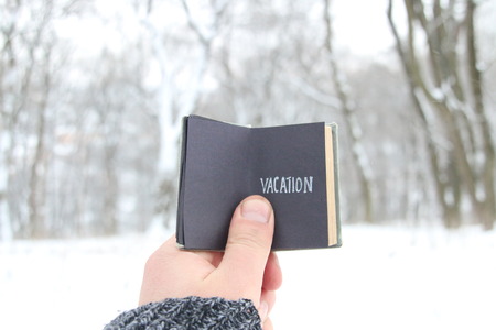 Vacation concept. Vintage book with inscriptionの写真素材