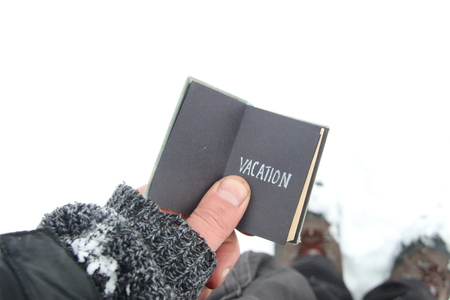 Vacation. Traveler holds the book with inscription.の写真素材