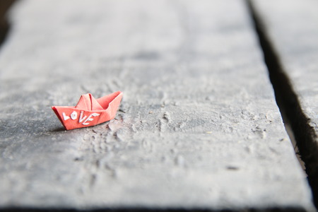 love idea, the inscription on a paper boat, Blurred photo for background.の写真素材
