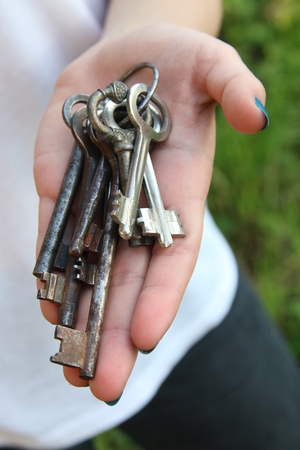 Girl holding vintage keys.の写真素材