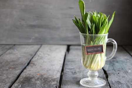 Healthy recipes. Wood garlic on vintage table and tag.の写真素材