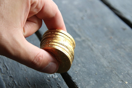 Businessman holds golden coins. Business profit concept.