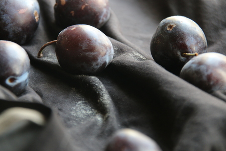 ripe delicious plums on the table, harvest conceptの写真素材