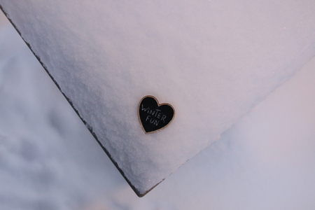 Winter Fun, heart shaped plate with the inscription lying in the snowの写真素材