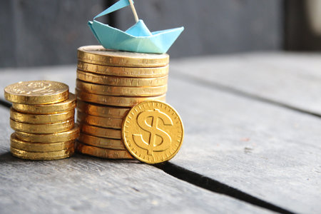 graph of gold coins and a paper boat, copy space