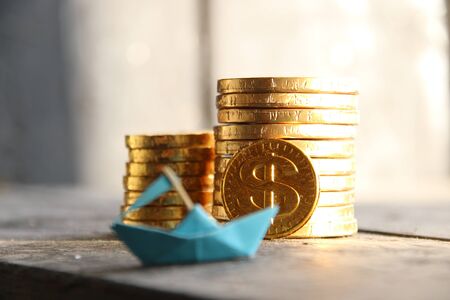 startup concept, graph of gold coins and a paper boatの写真素材
