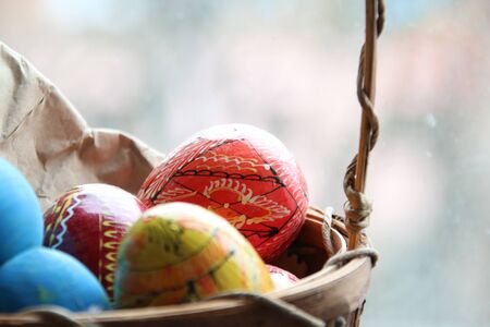 Wicker basket with easter eggs. Spring easter background with space for text.の写真素材