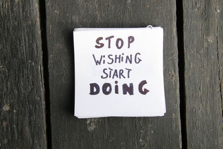 Stop dreaming start doing concept. Inspirational quote, motivation. Inscription on a sheet of paper.の写真素材