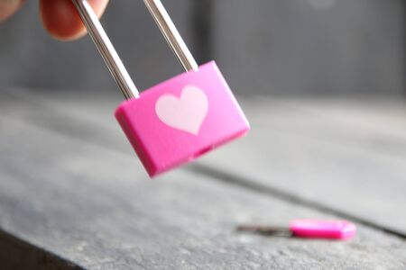 Lock and key to a heart for Valentines day. Love concept. Key and lock on the table.の写真素材