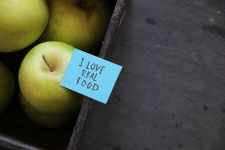 Healthy food concept. Green apples in a crate. And the tag with the inscription.の写真素材