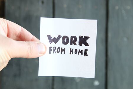 Work from home concept, note on vintage background.の写真素材