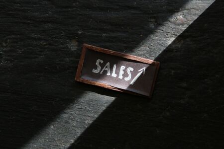 Sales growth idea, tag on a old vintage table.の写真素材