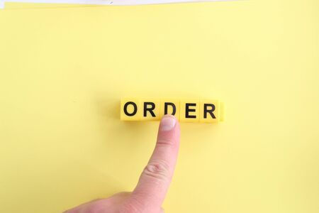 Concept for online orders and purchases. Hand clicking on an order button.の写真素材