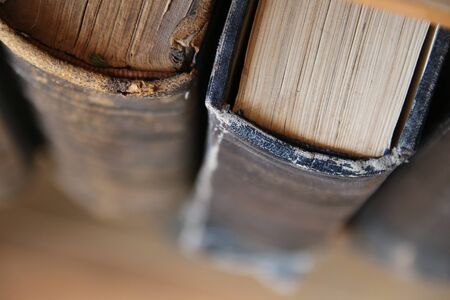 Bookshelves in the library with old books. Vintage style.の写真素材
