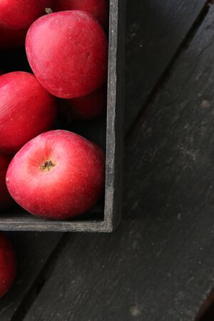 Ripe red apples in wooden box.  Vintag style.の写真素材
