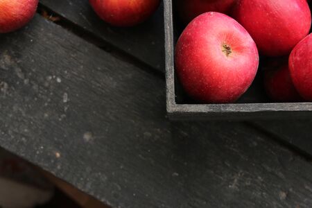 Ripe red apples in wooden box.  Vintag style.の写真素材