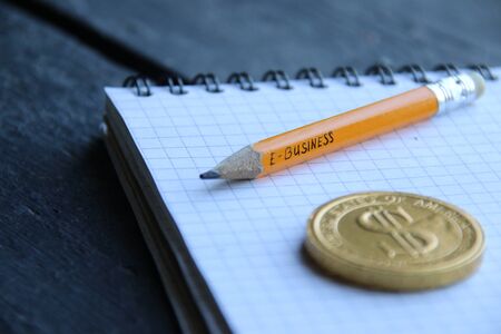 E-Business concept, gold coin and pencil with the inscription. Vintage style.の写真素材
