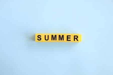 summer, lettering in yellow letters on a blue backgroundの写真素材