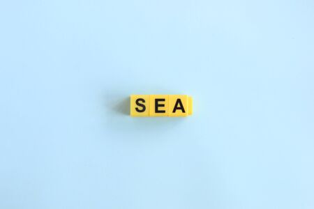sea concept, lettering in yellow letters on a blue backgroundの写真素材