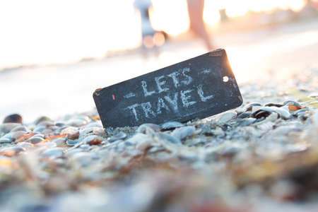 Lets Travel. Summer trip idea.A plate with the inscription on a beautiful beach.の写真素材