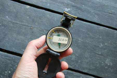 Pointer to the sea and an old compass. summer vacation concept.の写真素材