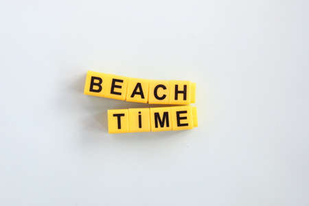 Beach time lettering in yellow cubes. Summer travel concept.の写真素材
