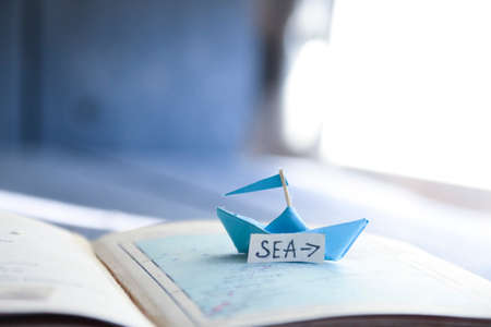 Sea idea. Paper boat on the map and inscription.の写真素材