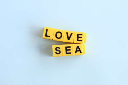 love sea concept, lettering in yellow letters on a blue backgroundの写真素材