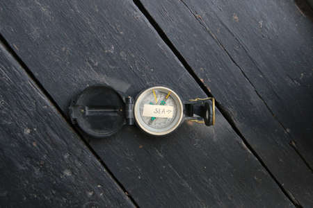 Pointer to the beach. Old compass and inscription.の写真素材