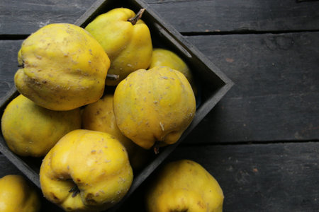 Ripe, fresh, biting quince on a vintage table. Food background.の写真素材