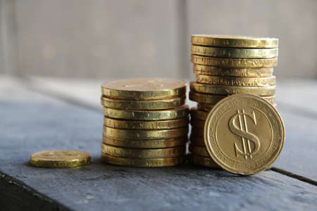 Profit growth concept. Graph of increasing income from gold coins.の写真素材