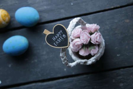 happy easter concept, basket of flowers and letteringの写真素材