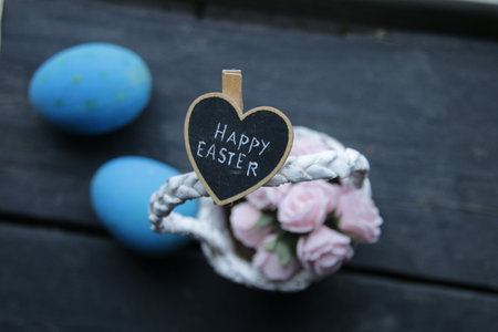 happy easter concept, basket of flowers and letteringの写真素材