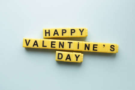 Happy Valentine's Day. An inscription made from yellow cubes. Creative concept.の写真素材