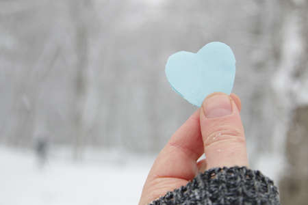 Happy valentines day. Hand holds a paper heart.の写真素材